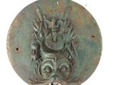 a bronze plaque with a bird and a fish on it