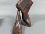 pair of men ' s brown leather ankle boots on a gray surface