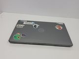 a laptop with stickers on it sitting on a table