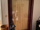 a mirror in the corner of a room with a bag on the floor