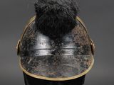 an old helmet with a fur ball on top of a mannequin head