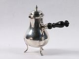 an antique silver coffee pot with a black handle on a white background