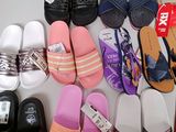 many pairs of slippers that are lined up on a table