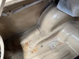 a dirty car that is sitting on the floor