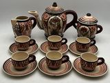 a lot of cups and saucers that are sitting on a table