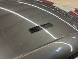 a sticker on the hood of a silver car