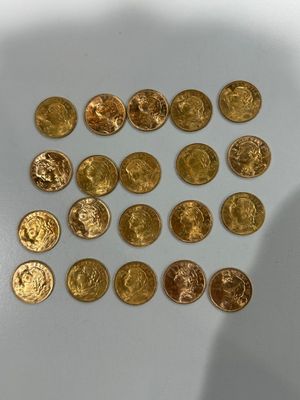 a lot of gold coins sitting on a white surface