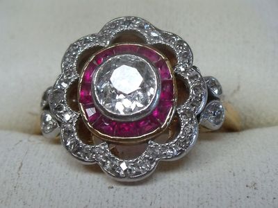 an image of a diamond and ruby ring