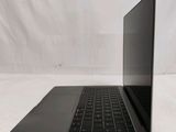 an open laptop computer sitting on top of a white surface