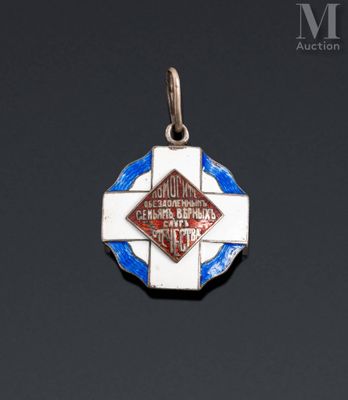 a silver and enamel medal with a blue and white cross on it