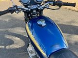 a blue motorcycle parked on the side of the street