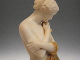 a statue of a woman with her hands on her chest