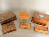 several wooden boxes are lined up in a row on a table