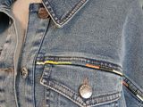 a close up of a denim jacket on a mannequin dummy