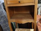 a small wooden table with a chair underneath it