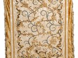 a beige and blue rug with a floral design on it