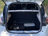 the back of a car with its trunk open and a laptop in the trunk