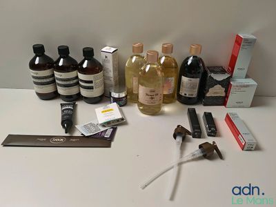 une table sur laquelle sont disposées de nombreuses bouteilles de liquides et d'autres objets