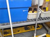 a large blue container sitting on top of a metal shelf