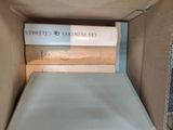 a cardboard box with a stack of books inside of it