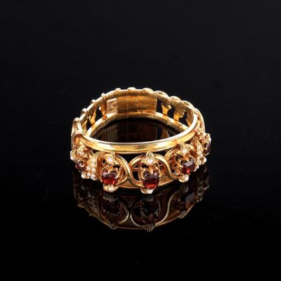 a close up of a gold ring on a black surface