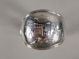 a close up of a silver ring with a coat of arms on it