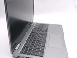 a silver laptop computer sitting on top of a white table