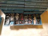 a blue box filled with assorted items on the floor