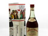 a bottle of liquor next to a box of wine