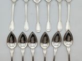 six silver spoons are lined up in a row on a table