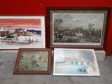 three framed pictures on the ground next to a red wall