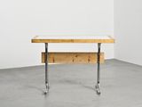 an image of a wooden table with metal legs in a white room