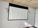 a projection screen in the corner of a room