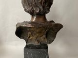 bronze bust of a young boy on a marble base