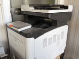 a printer sitting on top of a cabinet in a room