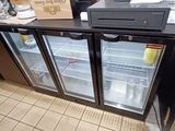 a counter with a refrigerator and a counter top with a box on it