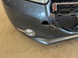 the front bumper of a car with a denting dent on it