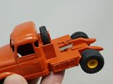 a person holding a toy truck in their hand