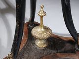 a small table with a black and gold decoration on it