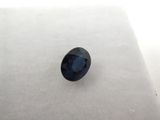 a blue sapphire stone sitting on top of a white surface