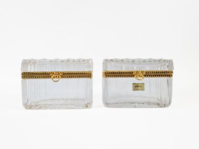a pair of clear glass boxes with gold trims