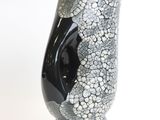a black and white vase with a black face on it