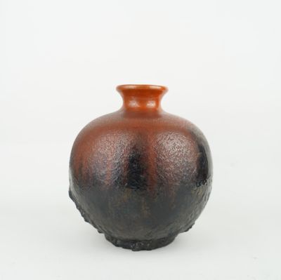 a small brown vase sitting on a white surface