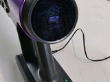 a purple hair dryer that is on a stand