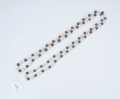 a close up of a rosary with a tag on it