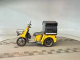 a yellow motorcycle with a cart on the back of it