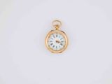 a close up of a pocket watch on a white surface