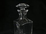 clear glass decanter on a black background with a black background