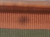 a close up of a piece of wood with a green and brown stripe