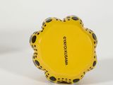 yellow and black polka dot ring with black dots on it